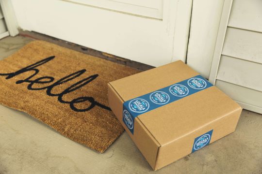 Brown kraft box delivered with a blue packaging tape design.