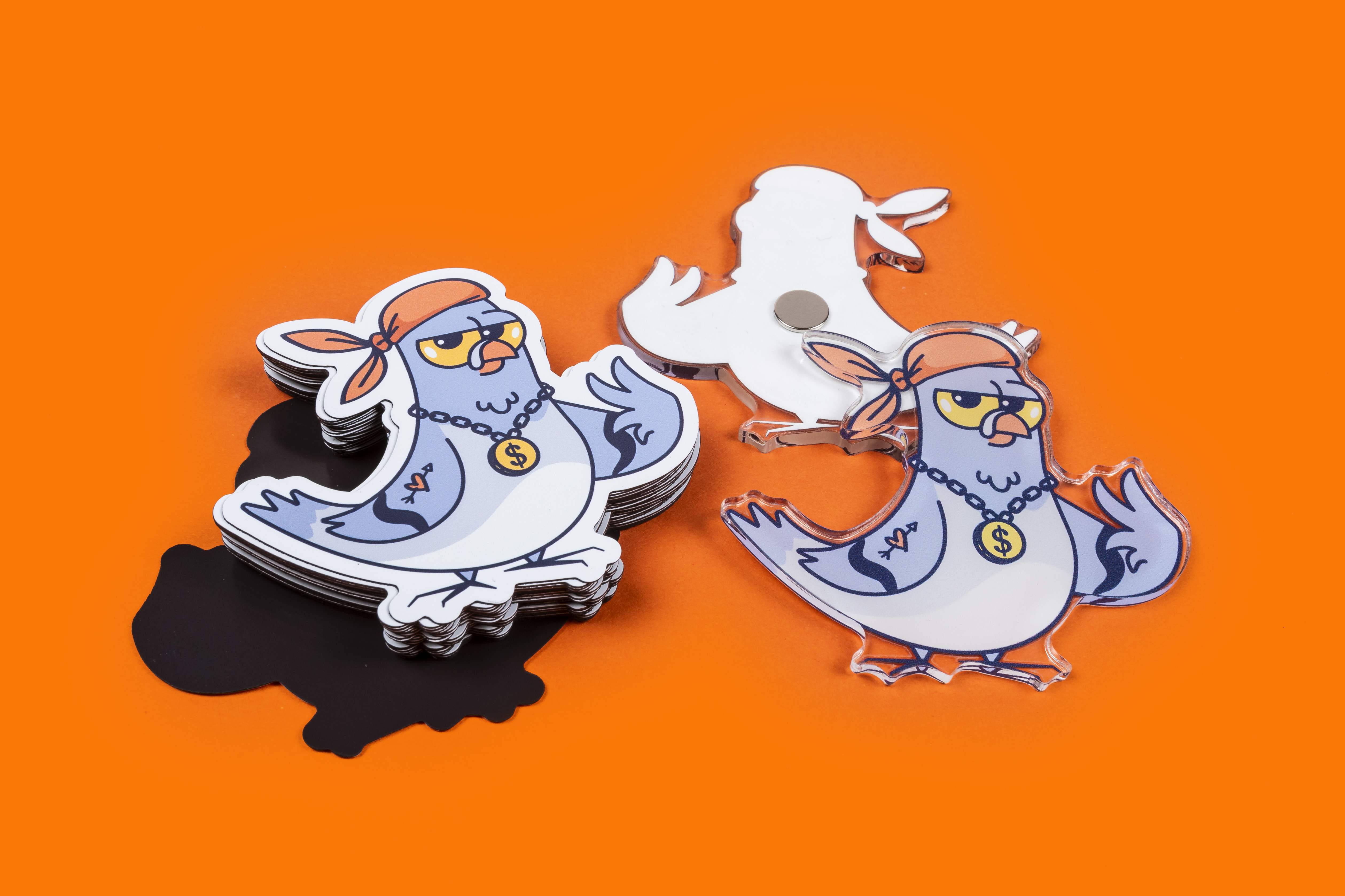 Image showing the front and back of both standard and acrylic magnets on an orange background
