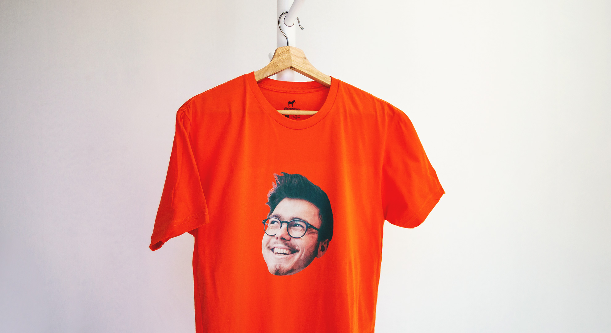 Orange custom t-shirt with a man's face with glasses