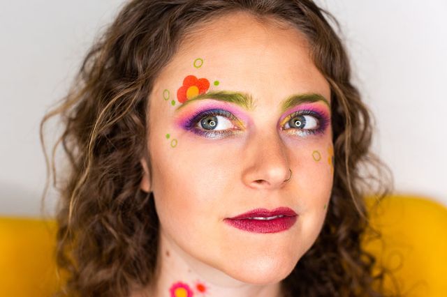 woman with custom temporary tattoos applied to her face