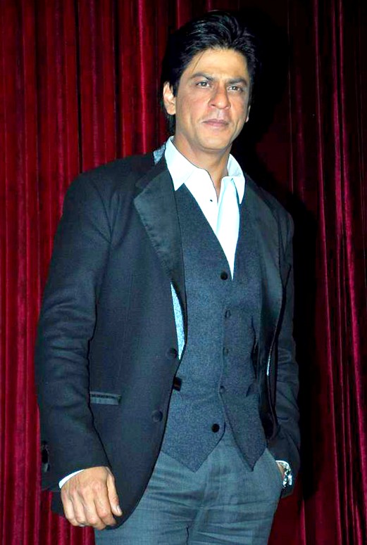 Man standing in blue jacket and vest, without a tie
