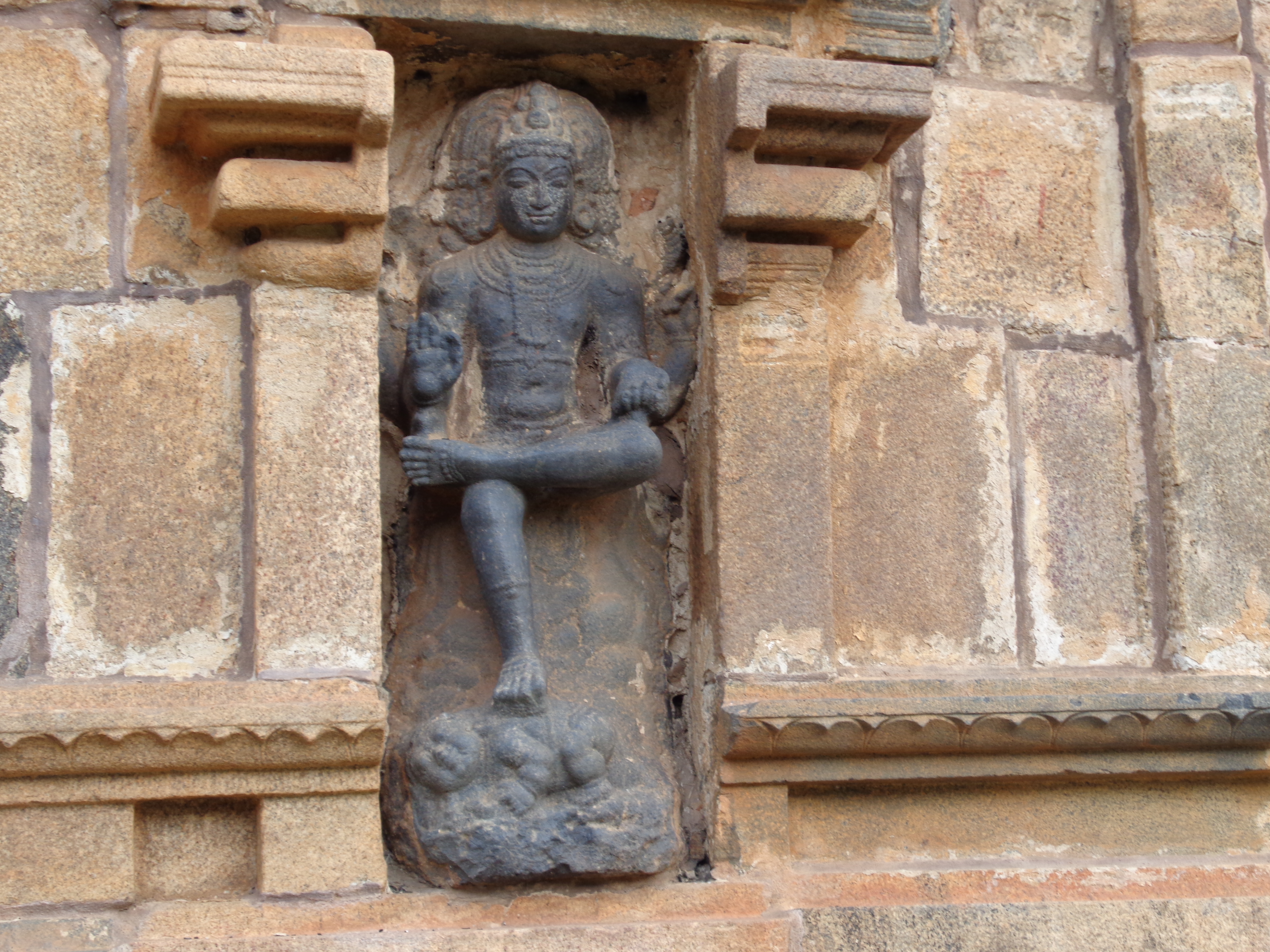 Dakshinamurti portrayed as the teacher of yoga, dance and sciences stepping over demon of ignorance.[48]
