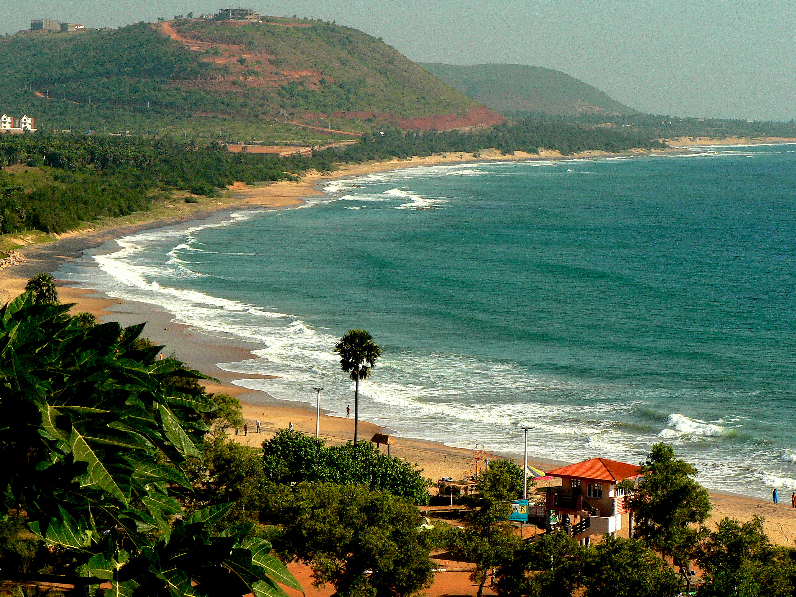 Sandy shoreline and waves at Rushikonda