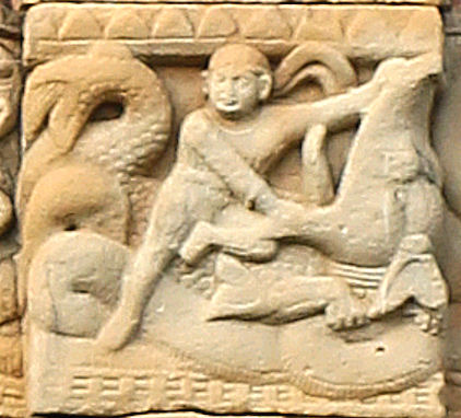 Hero with headband wrestling a Makara.