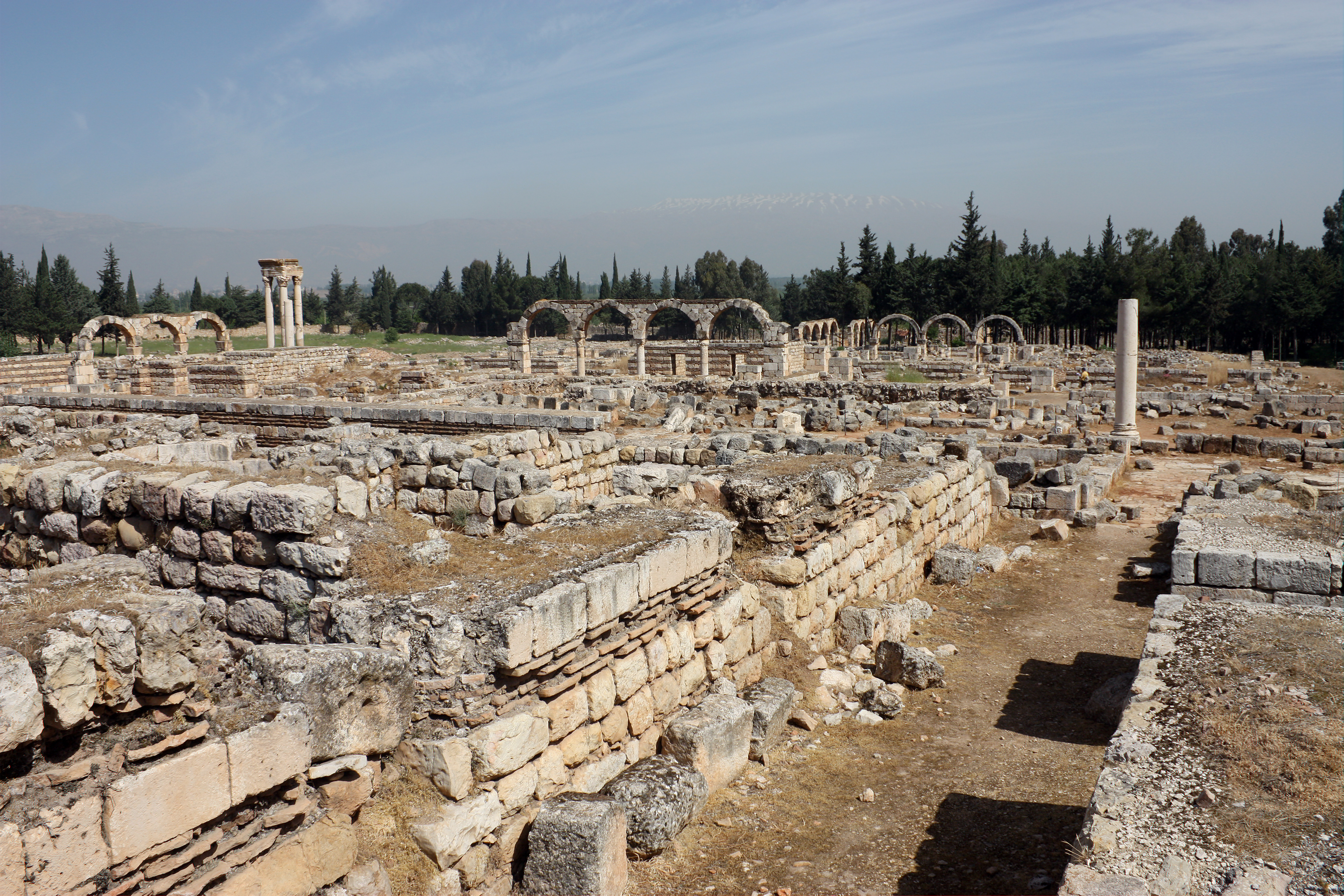 The strewn stone remains of an ancient city, including arcades
