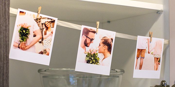 Photo display wire with retro prints in kitchen cupboards