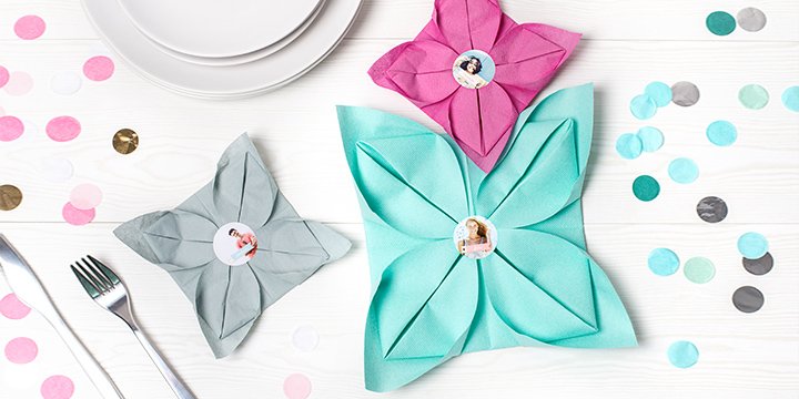 Personalised napkin stickers on colorful napkins folded like flowers