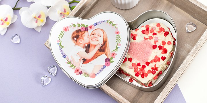 Frosted heart shaped chocolate cake in heart shaped cookie tin