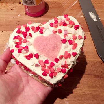 Heart shaped chocolate cake with frosting and decorations