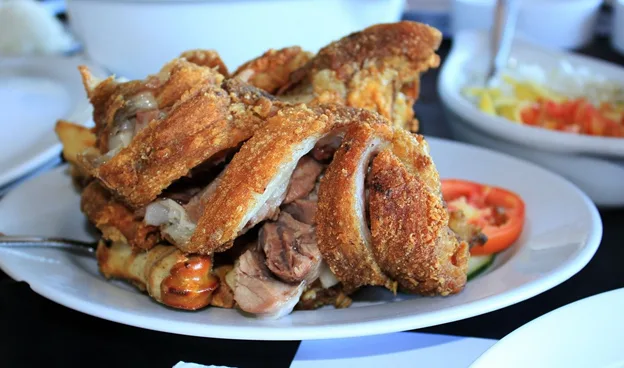 A vibrant spread of traditional Filipino Noche Buena dishes, including lechon, pancit, and spaghetti