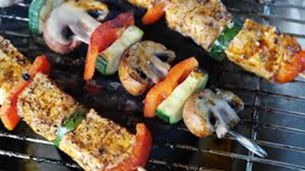 Hands preparing healthier food options, possibly showing fresh ingredients or alternative cooking methods