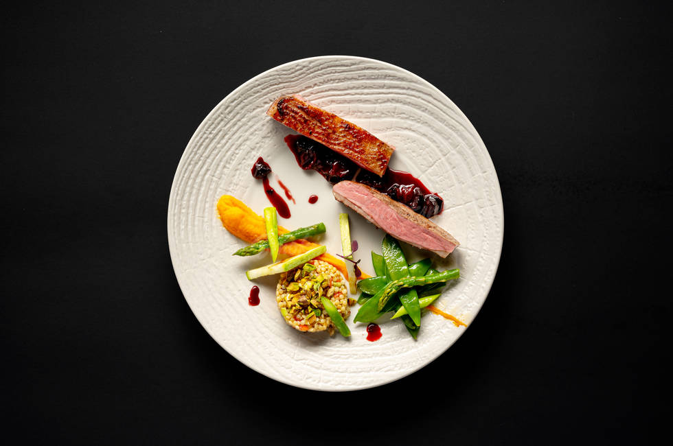 Duck magret with couscous and summer vegetables photo