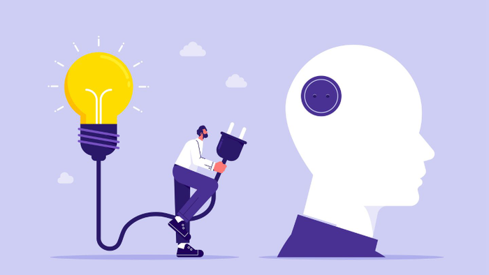 illustration of a person connecting the cord from a giant light bulb into a giant head