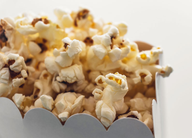 closeup of popcorn kernels in a white box