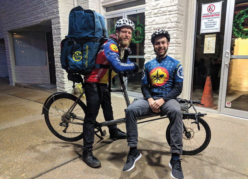 two bicycle delivery men with large backpacks