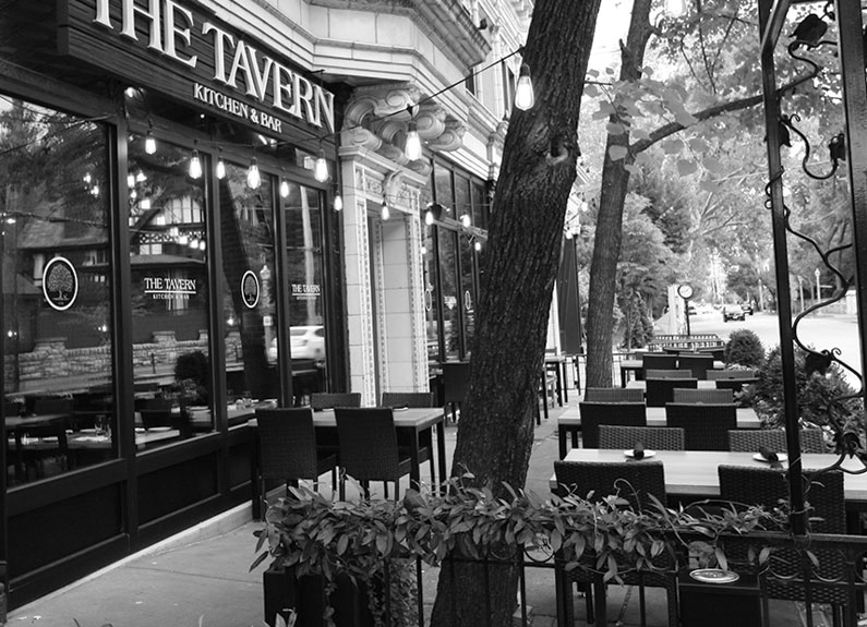 a black and white photo of the tavern in the central west end