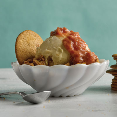 bowl of ice cream with rhubarb sauce and cookie