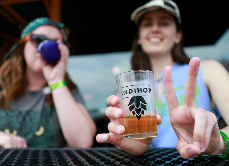 two people drinking beer at indihop beer festival in st. louis