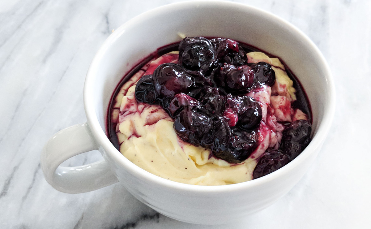 roasted blueberries atop vanilla pudding in a mug