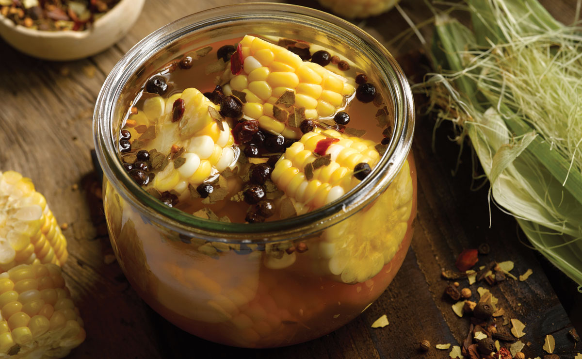 pickled corn on the cob in brine in a mason jar