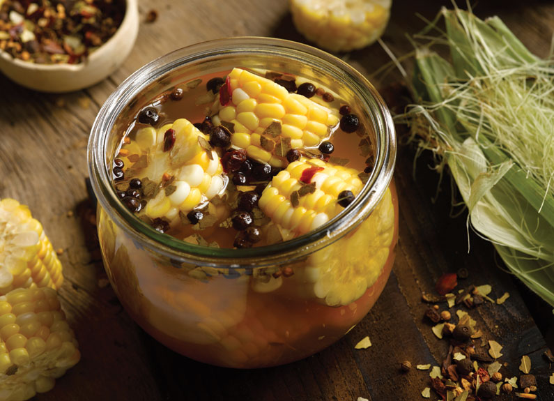 pickled corn on the cob in brine in a mason jar