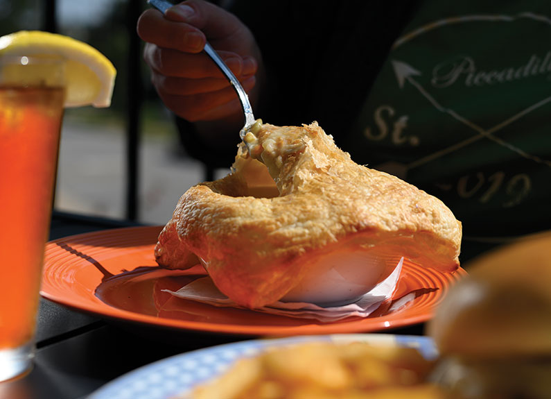 a spoon going into a chicken potpie