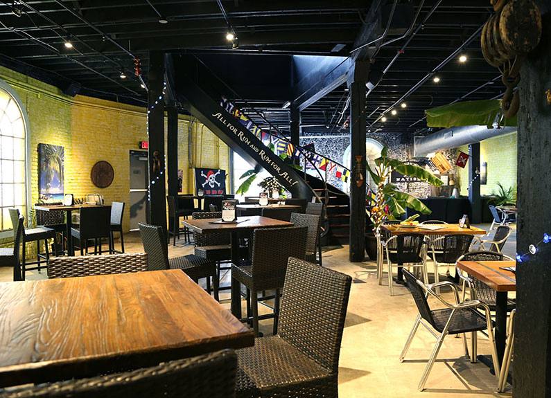 the interior of a warehouse tiki bar