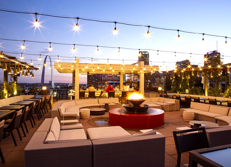 a hotel rooftop patio with a bonfire