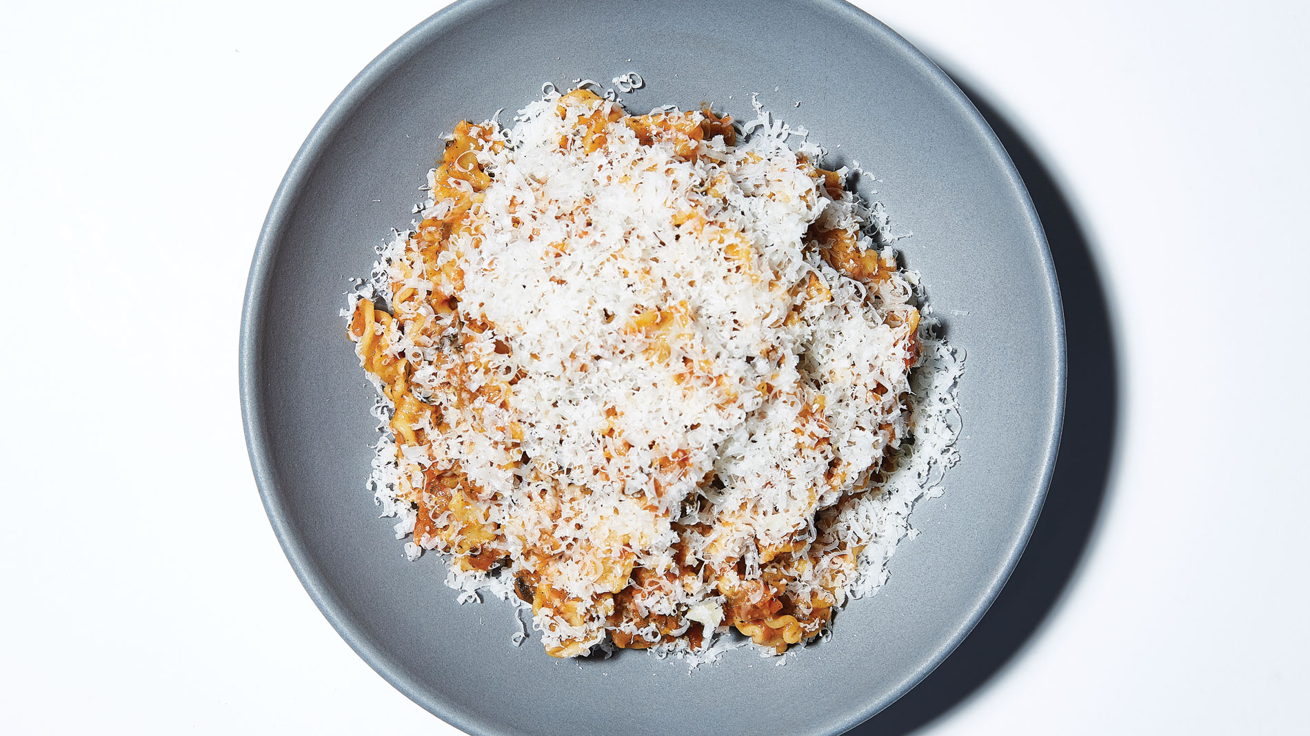 a dish of pasta covered in parmesan cheese