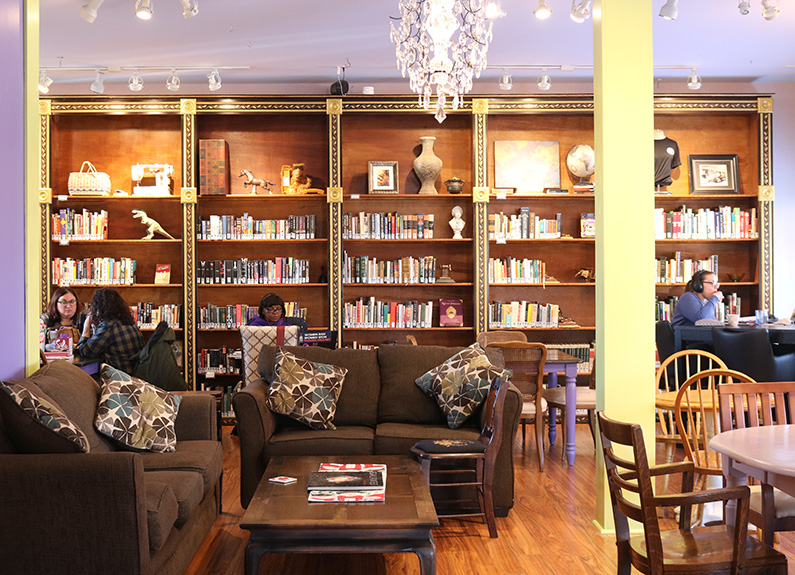 a cafe with walls of bookshelves