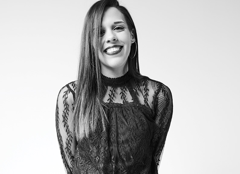 a young woman with long hair smiling at the camera