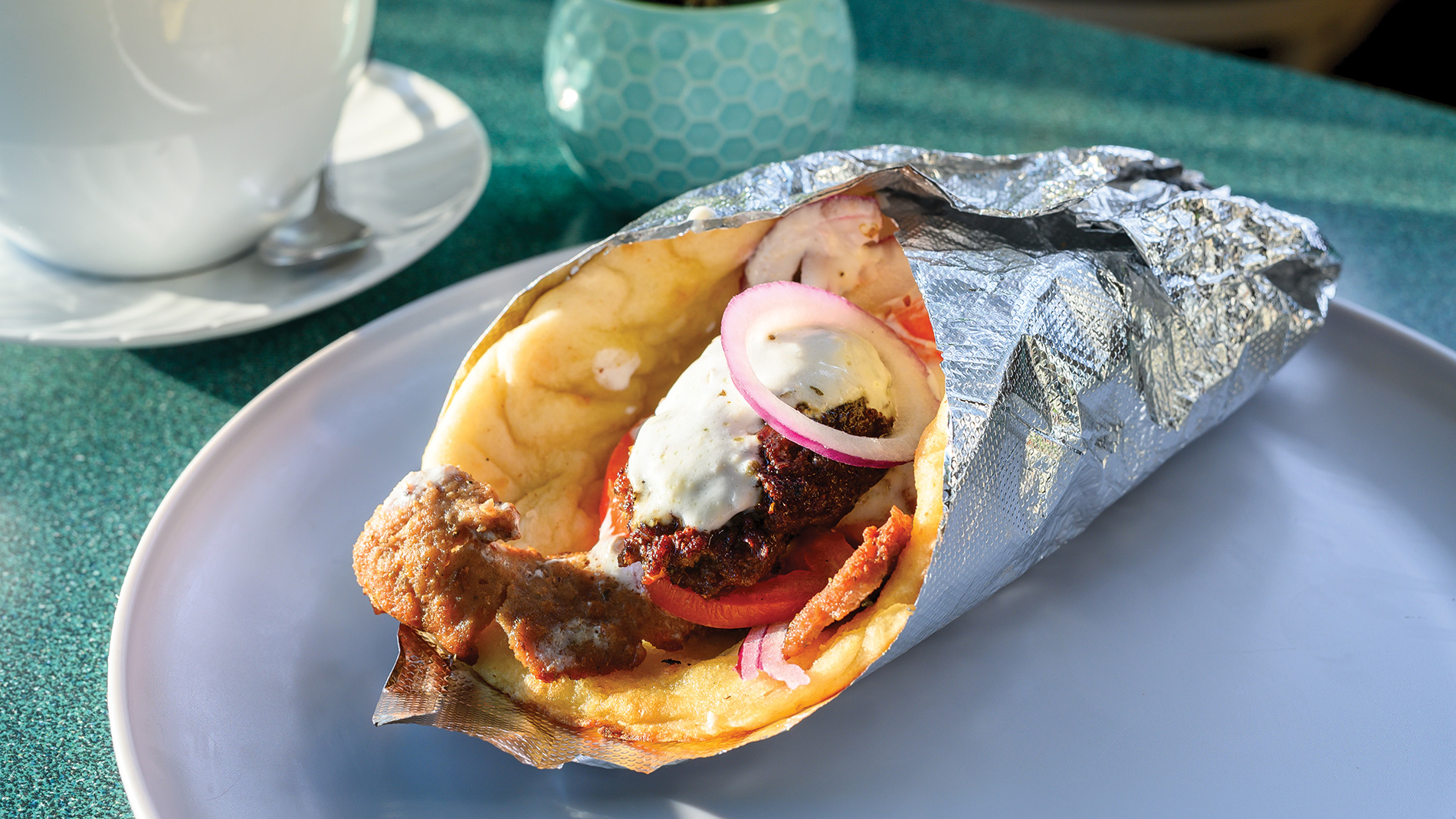 a gyro sandwich wrapped in foil