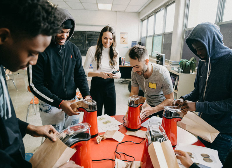 a group of students roasting coffee with popcorn poppers