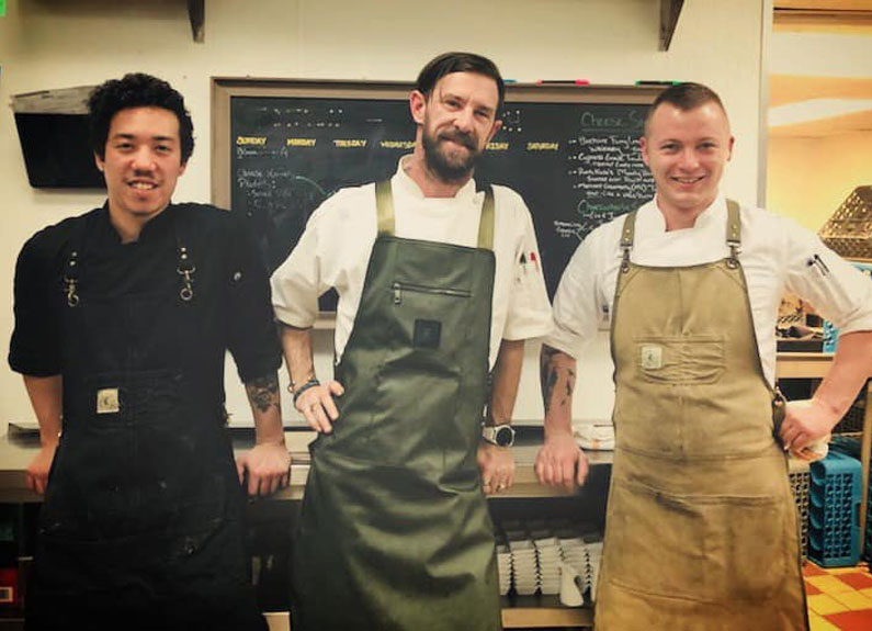 three men in aprons 