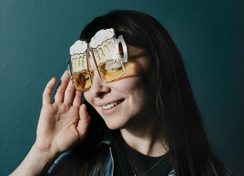 a woman with glasses shaped like beer mugs