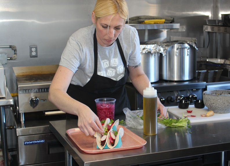 Plantain Girl Mandy Estrella works in the Alphateria kitchen at Alpha Brewing Co. in St. Louis