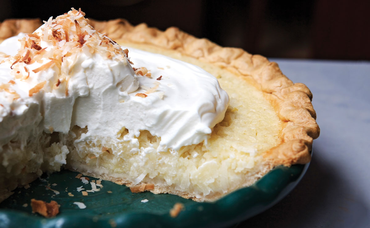 coconut pie with whipped cream and toasted coconut