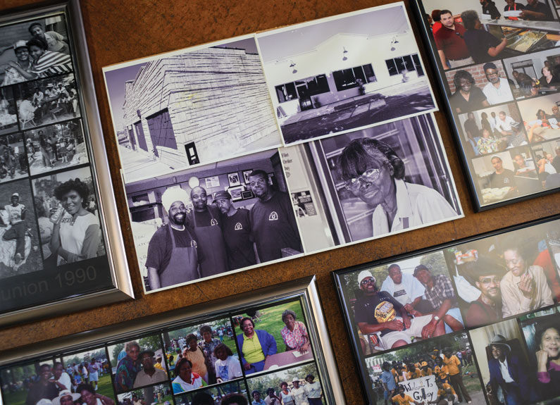 a wall of framed family photographs