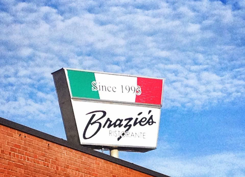 a sign with the italian tricolor on it and the word brazie's