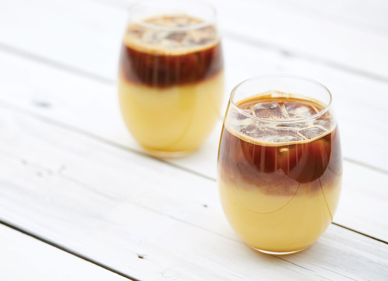 two nonalcoholic coffee drinks with orange juice topped with espresso