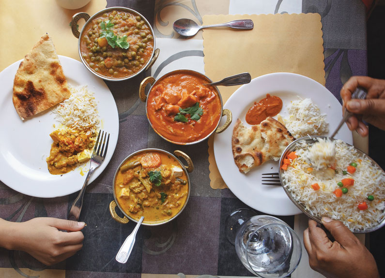 two people sharing an indian meal 