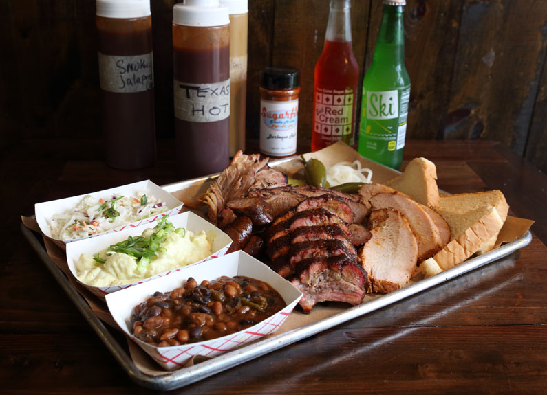 a tray of barbecue and sides