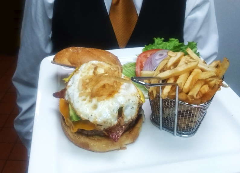 a plate with a cheeseburger and fries