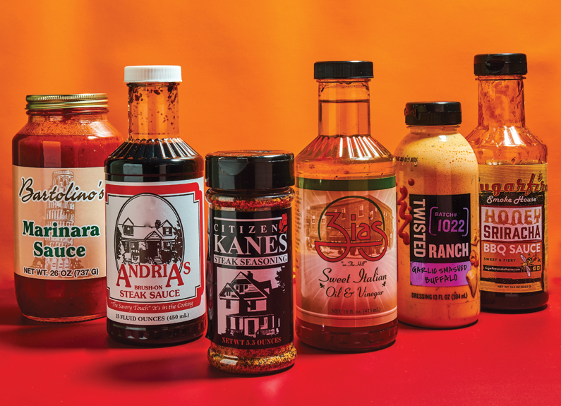 bottles of sauces and rubs on a fiery background