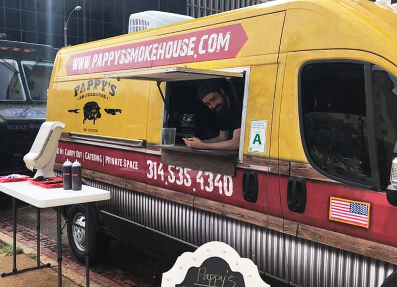 a man leaning out of a food truck