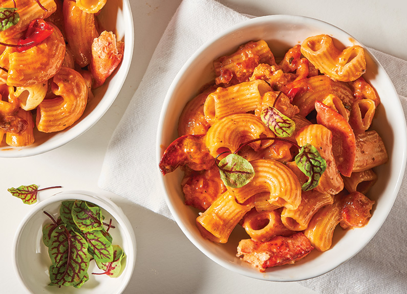 two bowls of pasta in red sauce