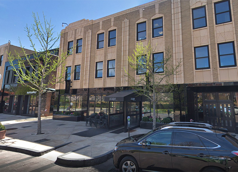 a brick building with a black awning