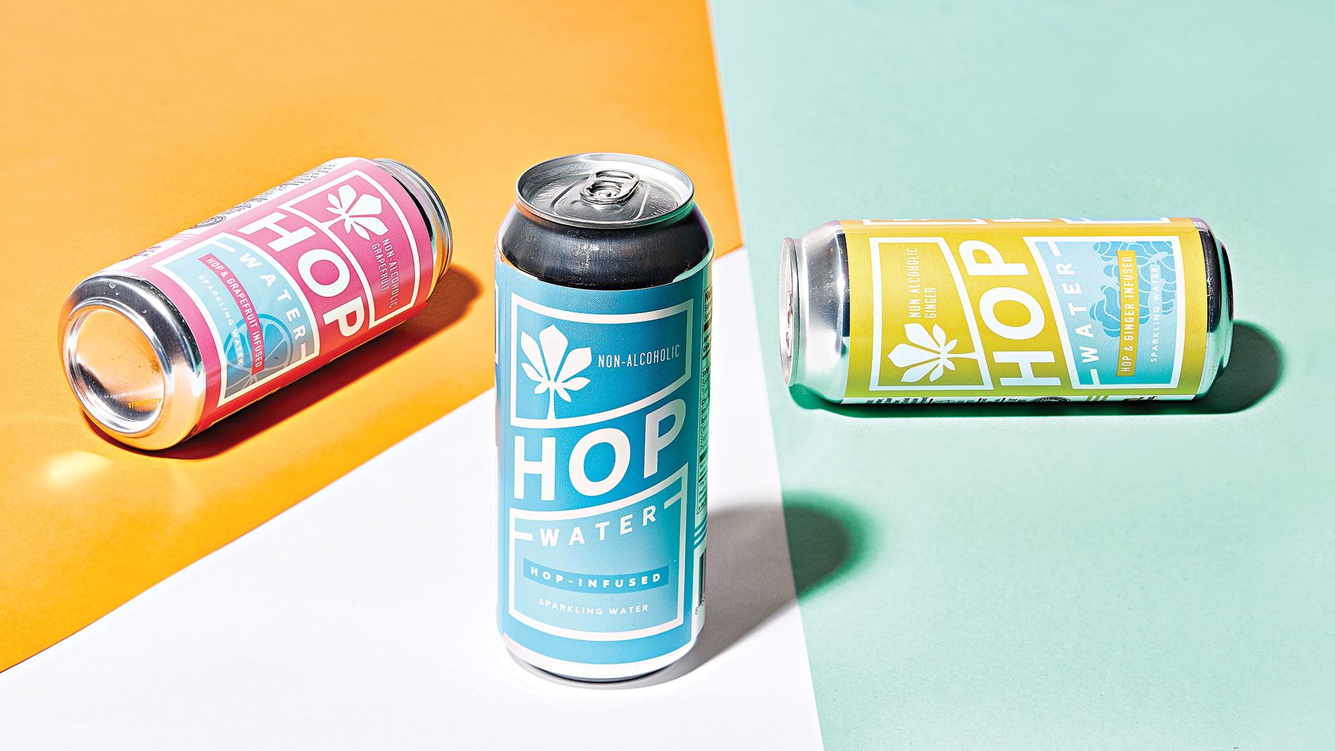 blue cans of hop water on a colorful background