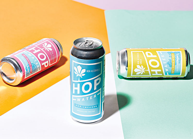 blue cans of hop water on a colorful background