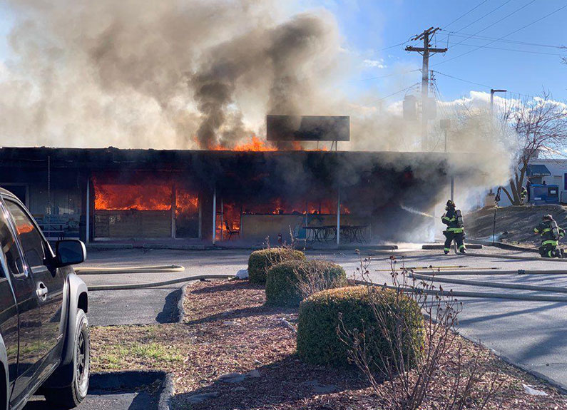 a firefighter battling a blaze 